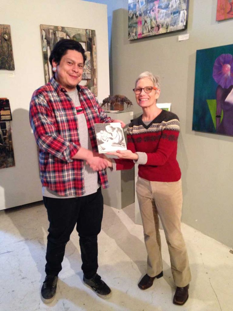 Josh Candelaria gives Adam Sturch artwork to Ruanna Waldrum